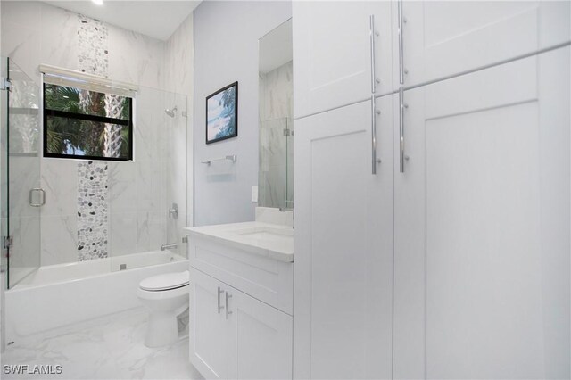 610 25th Ave NW, Naples, FL 34120 - full bath featuring marble finish flooring, toilet, vanity, and combined bath / shower with glass door