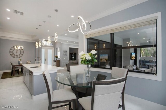 610 25th Ave NW, Naples, FL 34120 - dining area with crown molding, recessed lighting, a chandelier, and light marble finish flooring