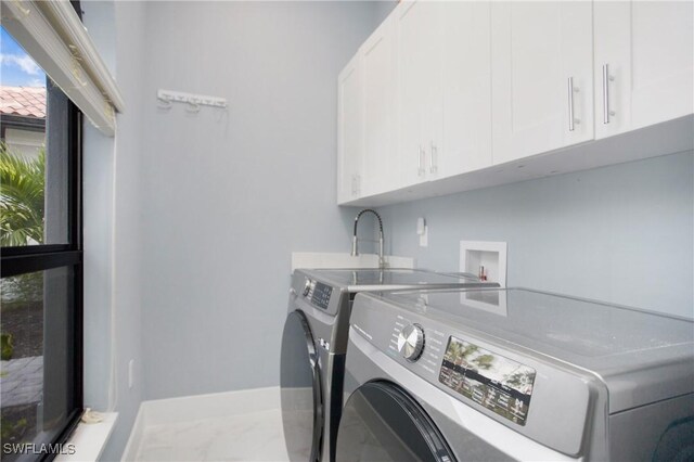 610 25th Ave NW, Naples, FL 34120 - laundry room featuring cabinet space, washer and clothes dryer, baseboards, and marble finish flooring