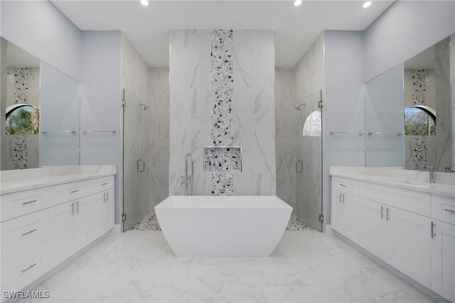 610 25th Ave NW, Naples, FL 34120 - full bath with a marble finish shower, two vanities, marble tiled floors, recessed lighting, and a freestanding tub