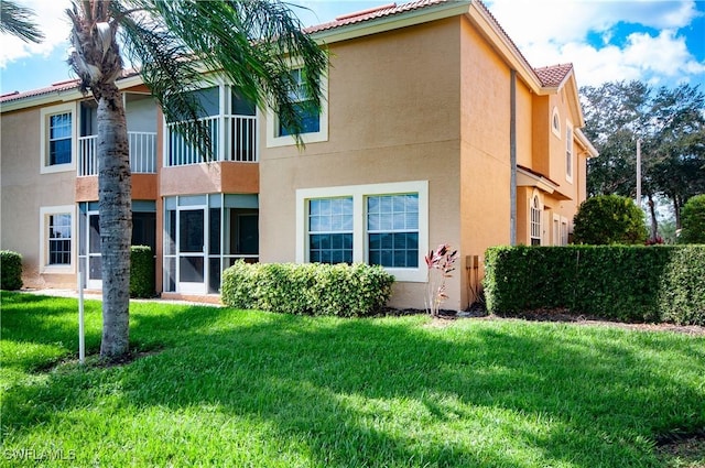 13020 Amberley Ct Unit 301, Bonita Springs, FL 34135 - back of house featuring stucco siding and a lawn