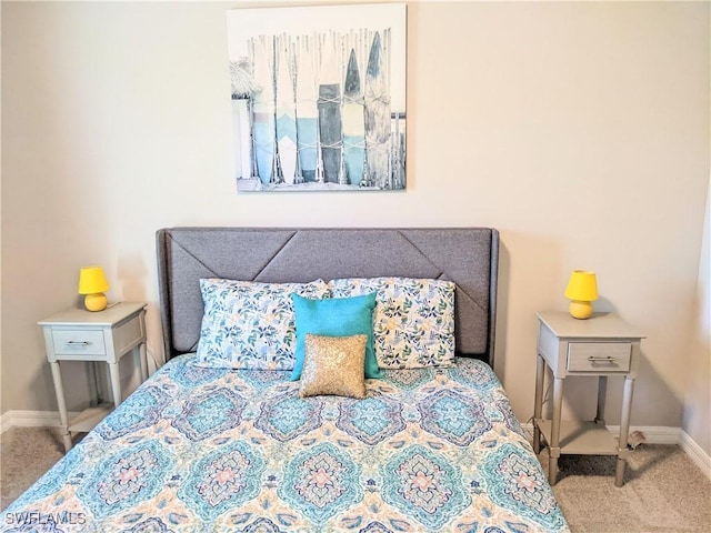 carpeted bedroom featuring baseboards