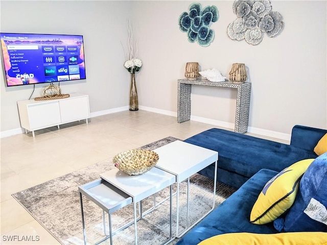 living area with tile patterned flooring and baseboards