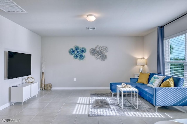 tiled living room featuring baseboards