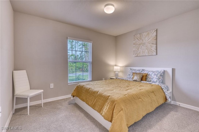 carpeted bedroom featuring baseboards
