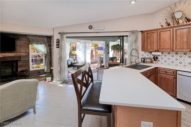 28427 Sabal Palm Dr, Punta Gorda, FL 33982 - kitchen featuring a sink, open floor plan, brown cabinets, stainless steel dishwasher, and vaulted ceiling