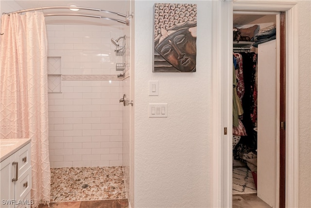 28427 Sabal Palm Dr, Punta Gorda, FL 33982 - bathroom featuring a stall shower, a walk in closet, vanity, and a textured wall