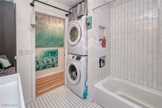 28427 Sabal Palm Dr, Punta Gorda, FL 33982 - full bathroom with stacked washer and clothes dryer, washtub / shower combination, and baseboards