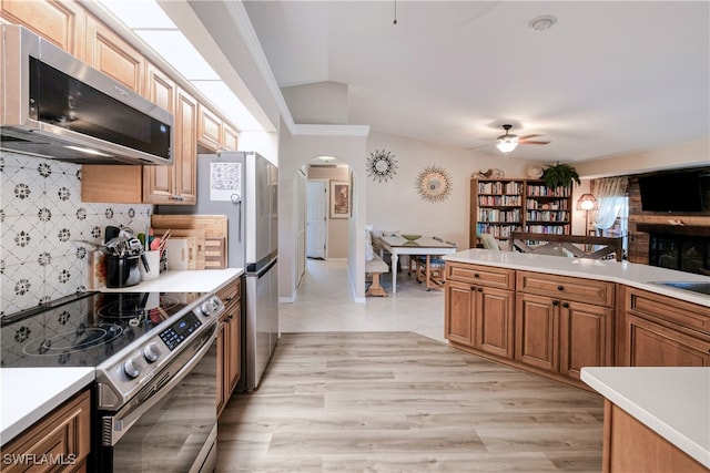 28427 Sabal Palm Dr, Punta Gorda, FL 33982 - kitchen with stainless steel appliances, arched walkways, decorative backsplash, light countertops, and lofted ceiling