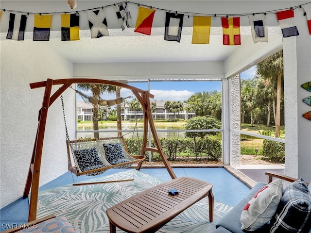 2110 Cay Lagoon Dr Unit 113, Naples, FL 34109 - sunroom featuring a textured wall and a water view