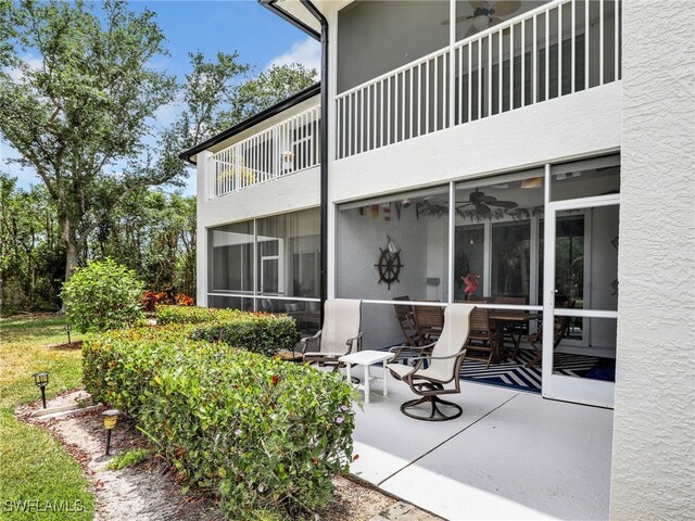 2110 Cay Lagoon Dr Unit 113, Naples, FL 34109 - rear view of property with a balcony, ceiling fan, and stucco siding