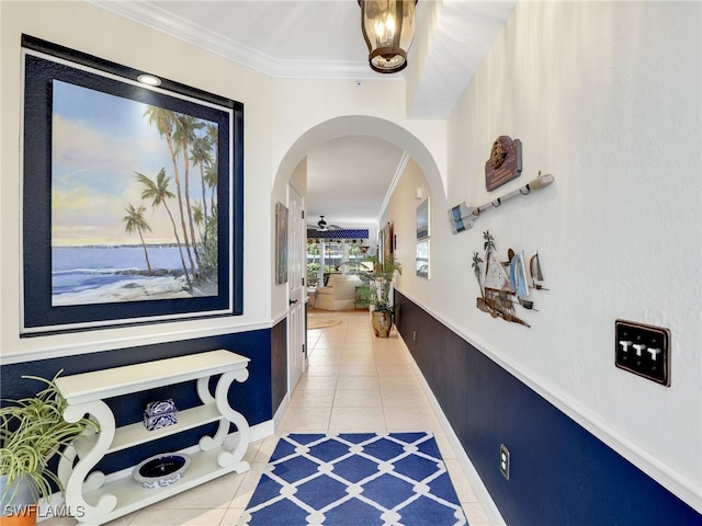 2110 Cay Lagoon Dr Unit 113, Naples, FL 34109 - hallway featuring light tile patterned floors, ornamental molding, arched walkways, and baseboards