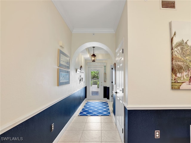 2110 Cay Lagoon Dr Unit 113, Naples, FL 34109 - hall featuring arched walkways, light tile patterned flooring, crown molding, and baseboards
