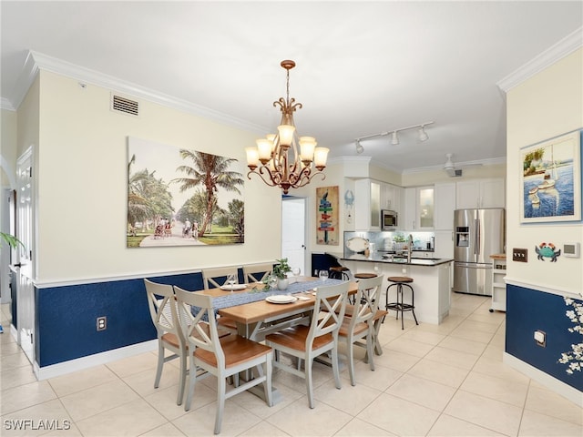 2110 Cay Lagoon Dr Unit 113, Naples, FL 34109 - dining room with crown molding, light tile patterned floors, a chandelier, and baseboards