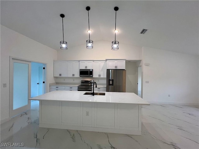 kitchen featuring stainless steel appliances, light marble finish floors, a sink, white cabinets, and a kitchen island with sink