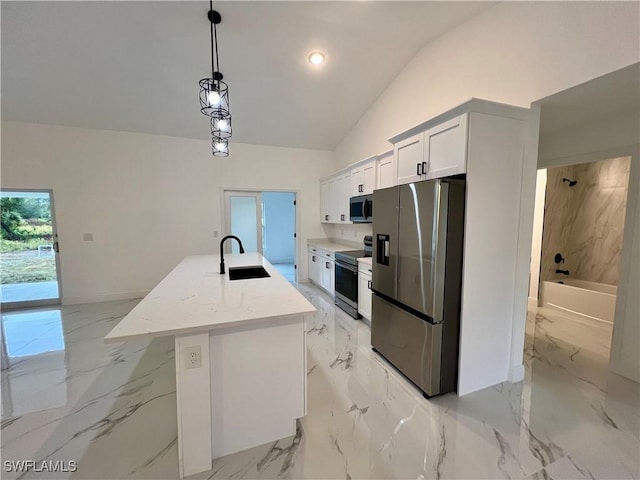 kitchen featuring stainless steel appliances, a sink, lofted ceiling, light marble finish floors, and a kitchen island with sink