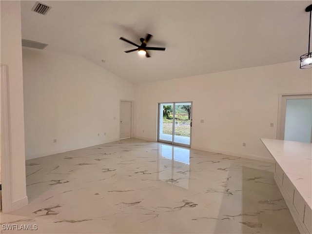 spare room featuring ceiling fan, baseboards, vaulted ceiling, and light marble finish floors