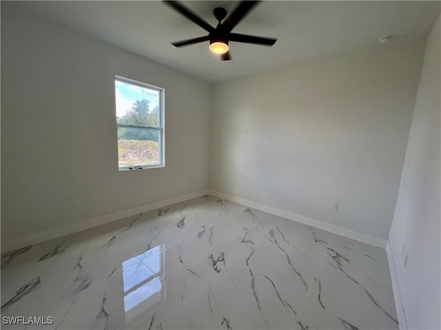 empty room with baseboards, light marble finish flooring, and ceiling fan