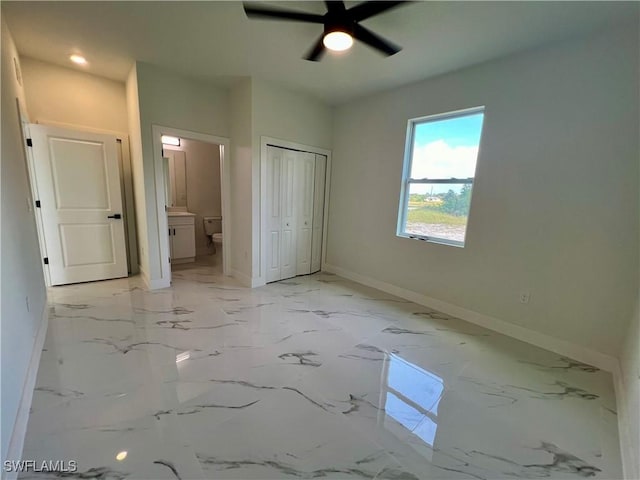 unfurnished bedroom featuring baseboards, recessed lighting, ensuite bathroom, a closet, and light marble finish flooring