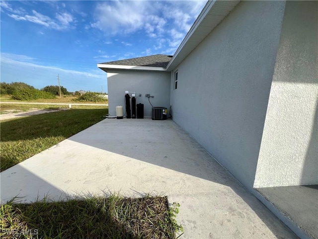 view of property exterior featuring a patio area, stucco siding, and a yard