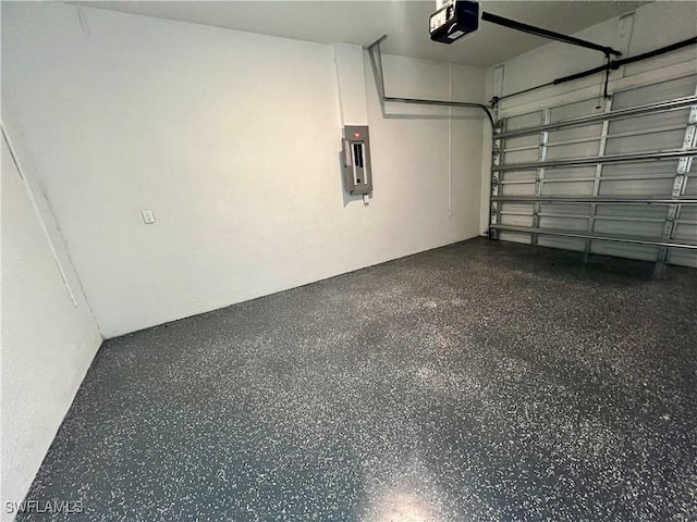 garage featuring electric panel and a garage door opener