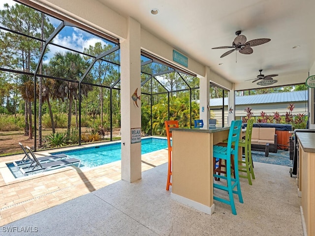 3818 2nd Ave NE, Naples, FL 34120 - outdoor pool with a covered hot tub, a patio area, glass enclosure, and ceiling fan
