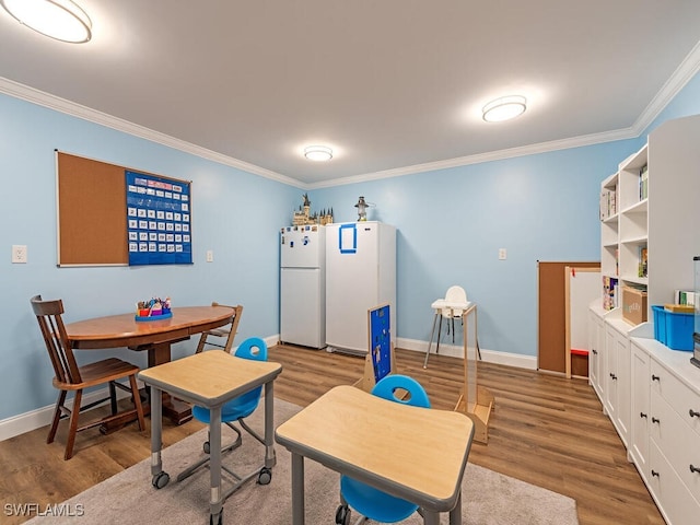 3818 2nd Ave NE, Naples, FL 34120 - dining space with crown molding, wood finished floors, and baseboards