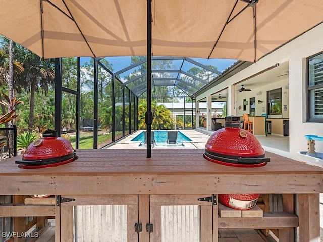 3818 2nd Ave NE, Naples, FL 34120 - swimming pool featuring ceiling fan, glass enclosure, and a patio area