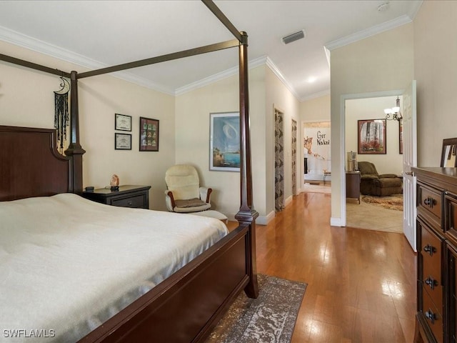 7930 Wexford Dr, Naples, FL 34104 - bedroom featuring wood finished floors, crown molding, baseboards, lofted ceiling, and a chandelier