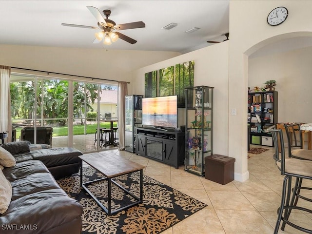 7930 Wexford Dr, Naples, FL 34104 - living room featuring a ceiling fan, arched walkways, lofted ceiling, and light tile patterned floors