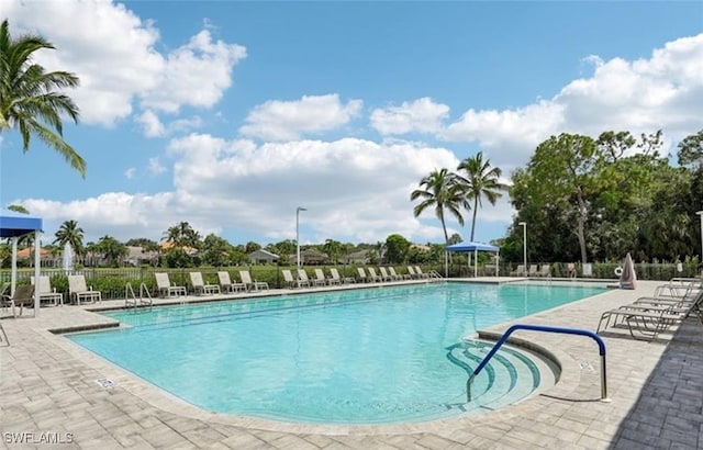 7930 Wexford Dr, Naples, FL 34104 - community pool with a patio and fence