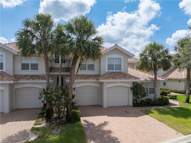 3471 Ballybridge Cir Unit 202, Bonita Springs, FL 34134 - multi unit property featuring an attached garage, stucco siding, driveway, and a tile roof