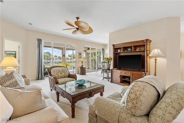3471 Ballybridge Cir Unit 202, Bonita Springs, FL 34134 - living area featuring ceiling fan, light carpet, and plenty of natural light