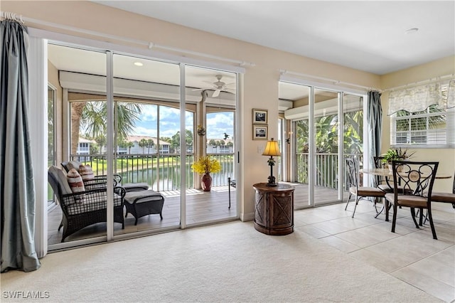 3471 Ballybridge Cir Unit 202, Bonita Springs, FL 34134 - sunroom featuring plenty of natural light, tile patterned floors, a water view, and carpet flooring