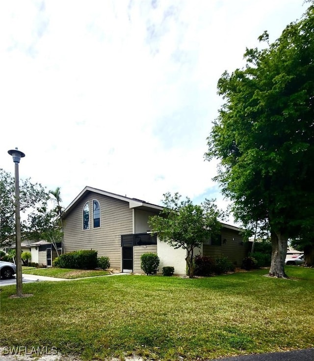 view of side of property with a lawn