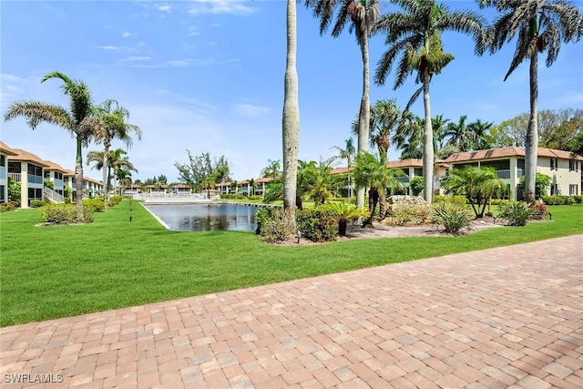 1155 Sandpiper St Unit G2, Naples, FL 34102 - view of community featuring a water view, a yard, and a residential view