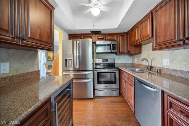 1155 Sandpiper St Unit G2, Naples, FL 34102 - kitchen with appliances with stainless steel finishes, beverage cooler, a sink, a tray ceiling, and ceiling fan