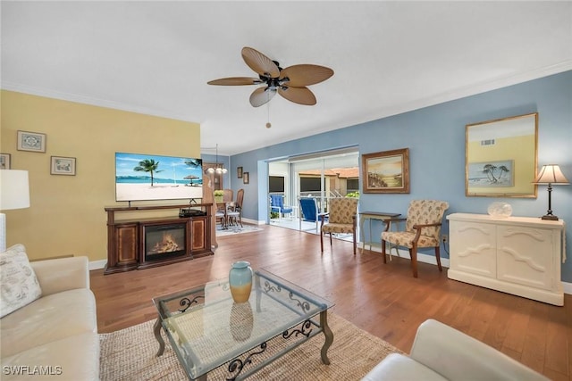 1155 Sandpiper St Unit G2, Naples, FL 34102 - living area featuring wood finished floors, ceiling fan, baseboards, and ornamental molding