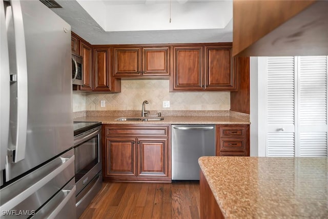 1155 Sandpiper St Unit G2, Naples, FL 34102 - kitchen featuring stainless steel appliances, a sink, dark wood-style floors, and backsplash