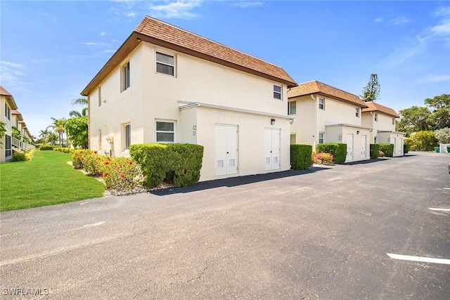 1155 Sandpiper St Unit G2, Naples, FL 34102 - view of front of house with stucco siding and a front lawn