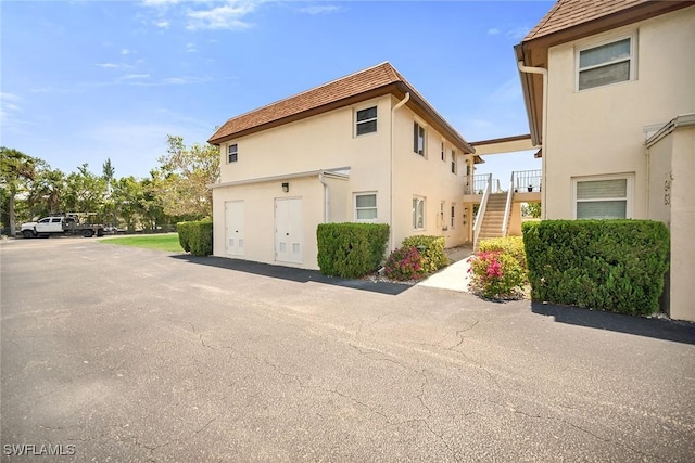 1155 Sandpiper St Unit G2, Naples, FL 34102 - view of side of home with stairs and stucco siding