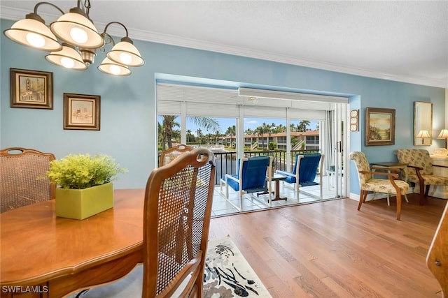 1155 Sandpiper St Unit G2, Naples, FL 34102 - dining space with ornamental molding, wood finished floors, plenty of natural light, and a chandelier