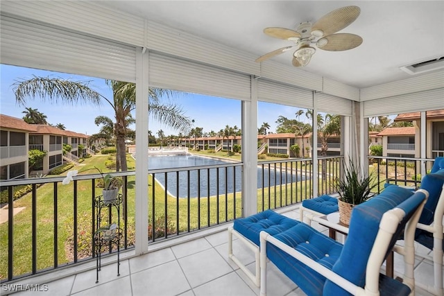 1155 Sandpiper St Unit G2, Naples, FL 34102 - sunroom with a water view, a ceiling fan, and plenty of natural light