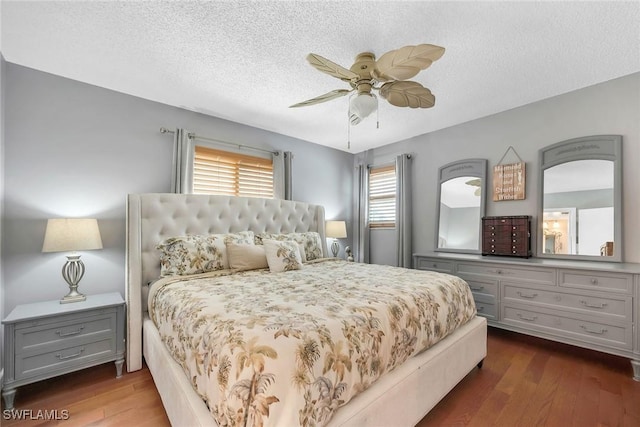 1155 Sandpiper St Unit G2, Naples, FL 34102 - bedroom featuring dark wood-style flooring, a textured ceiling, and a ceiling fan