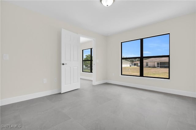 spare room with baseboards