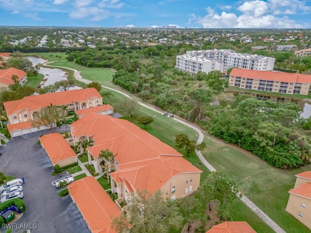 26660 Rosewood Pointe Cir Unit 205, Bonita Springs, FL 34135 - drone / aerial view of a nearby body of water, a golf course, and apartment complex