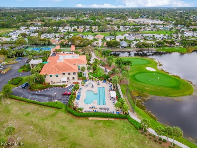 view of property location with a nearby body of water, a pool area, a golf course, and nearby suburban area