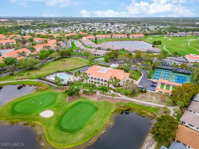 aerial view of residential area featuring a large body of water and a local golf course