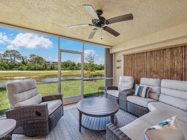 sunroom / solarium featuring a water view, an outdoor hangout area, and a ceiling fan