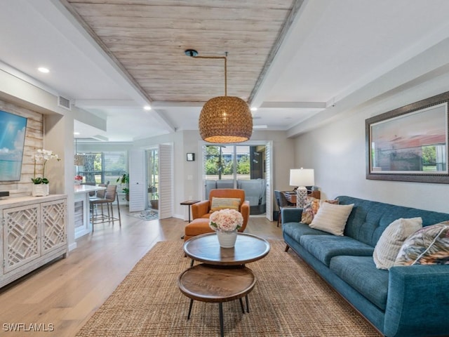 living room with light wood finished floors, beamed ceiling, and recessed lighting